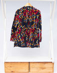 The display of navy shirt with red, orange, yellow and white geometric print