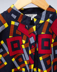 The display of navy shirt with red, orange, yellow and white geometric print