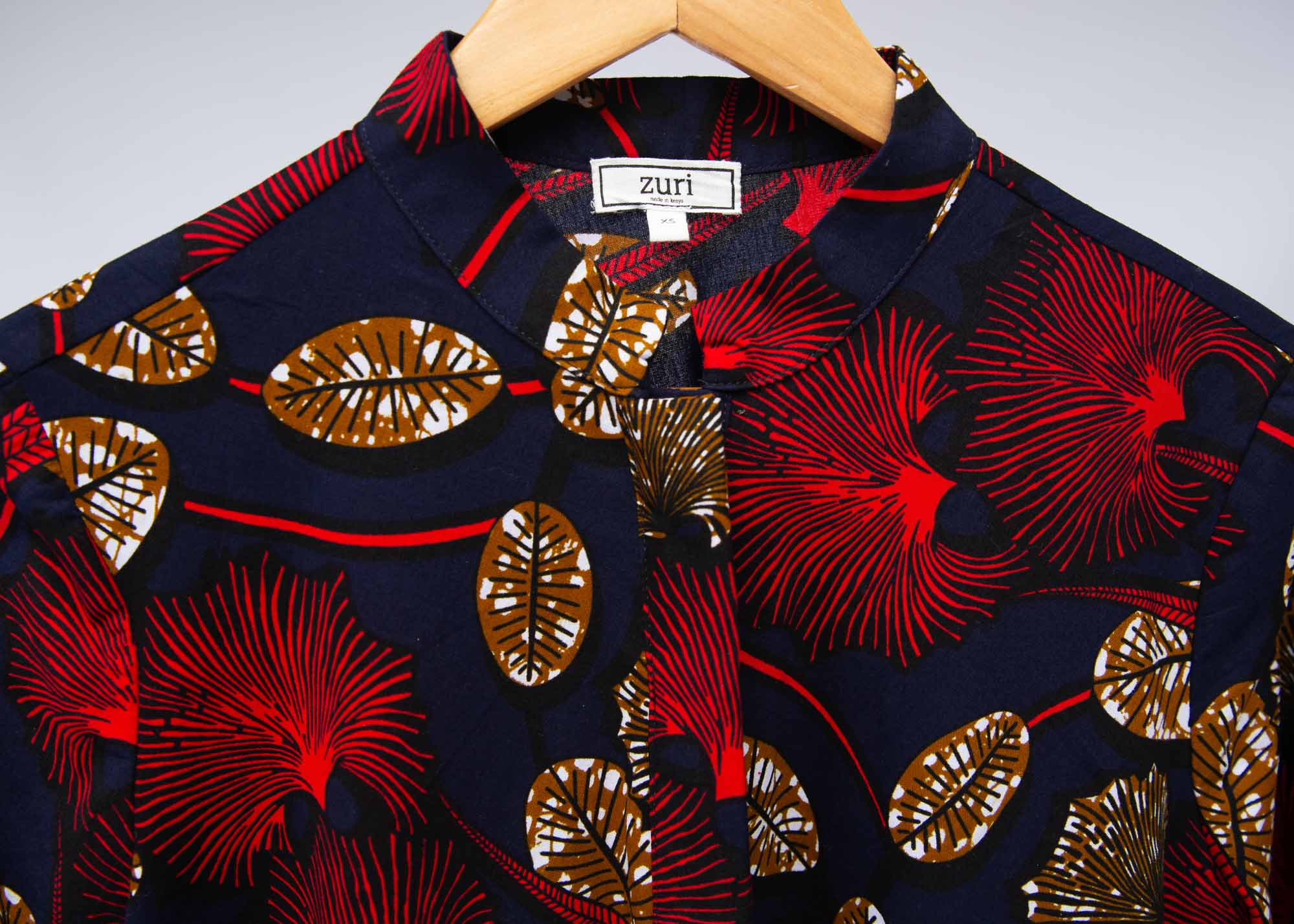 The display of navy dress with red, white and orange floral print