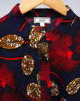 The display of navy dress with red, white and orange floral print