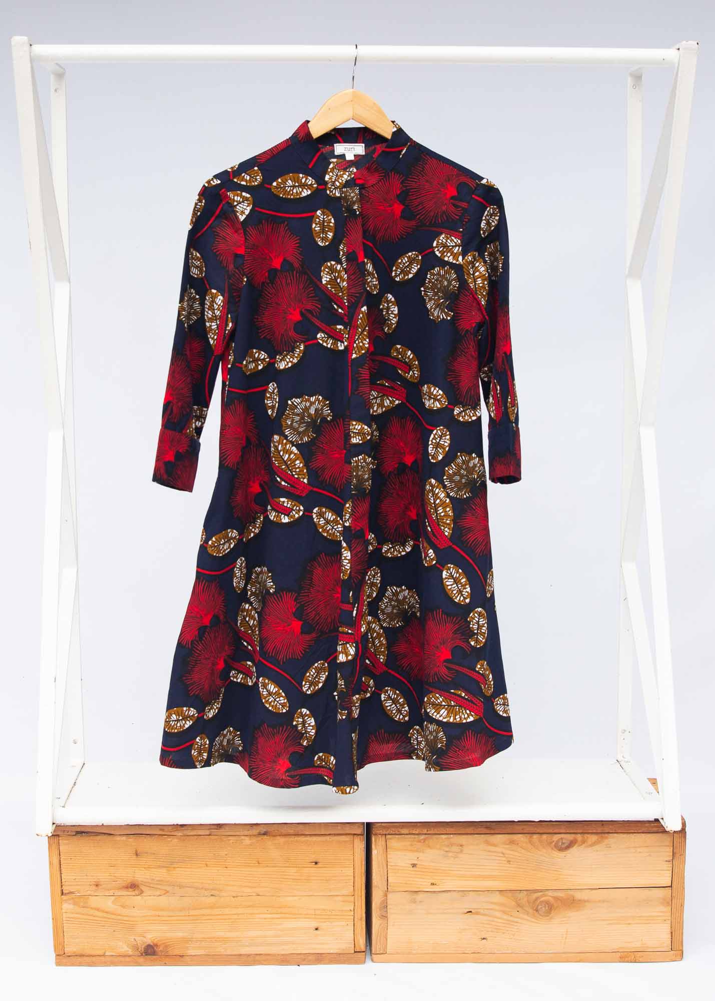The display of navy dress with red, white and orange floral print