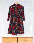 The display of navy dress with red, white and orange floral print