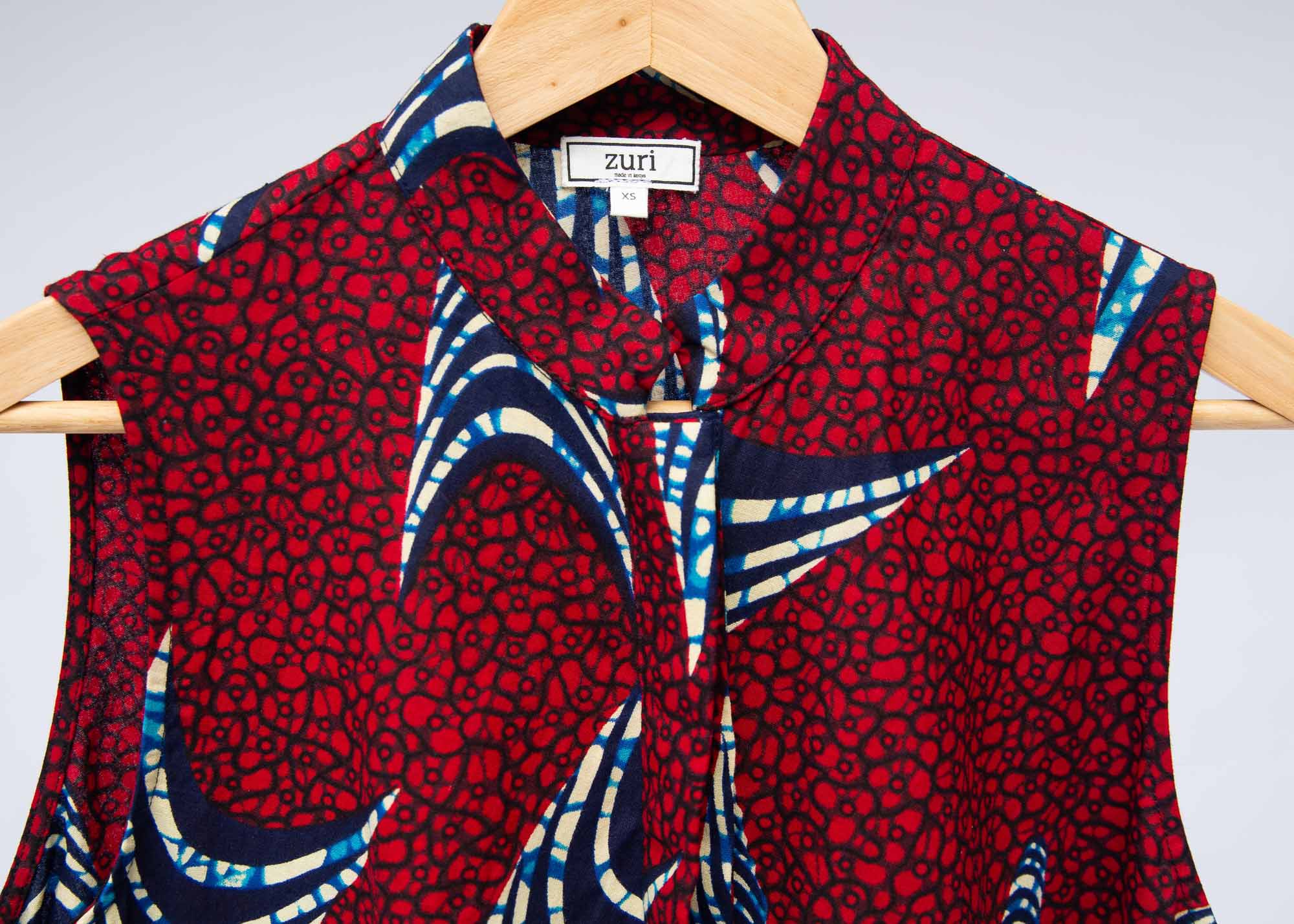 The display of red and black dress with navy blue and beige print