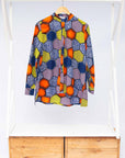 Display of multicolored long sleeved shirt with geometric print