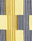 Close up display of yellow and black striped dress, fabric.