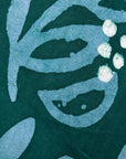 Close up display of green and blue floral batik dress, fabric