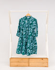 Display of green and blue floral batik dress.