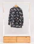 Display of black and white long sleeve shirt with Zuri graphic print.