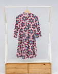 Display of dress with yellow, red and blue bug print.