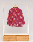 Display of red shirt with orange and white gumball print.