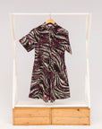 Display of pink, black and white glitter print dress.