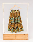 Display of orange and green geometric print pants.