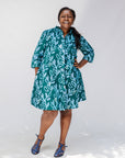 Model wearing green and blue floral batik dress.