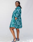 Model wearing green and blue floral batik dress.