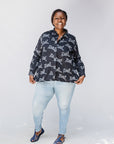 Model wearing black and white long sleeve shirt with Zuri graphic print.
