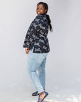 Model wearing black and white long sleeve shirt with Zuri graphic print.