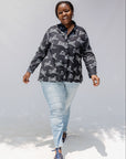 Model wearing black and white long sleeve shirt with Zuri graphic print.