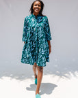 Model wearing green and blue floral batik dress.