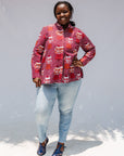 Model wearing red shirt with orange and white gumball print.