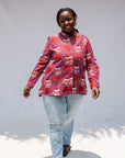 Model wearing red shirt with orange and white gumball print.