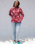 Model wearing red shirt with orange and white gumball print.