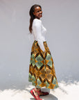 Model wearing orange and green geometric print pants.
