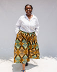 Model wearing orange and green geometric print pants.