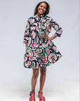 Model wearing colorful abstract print dress.