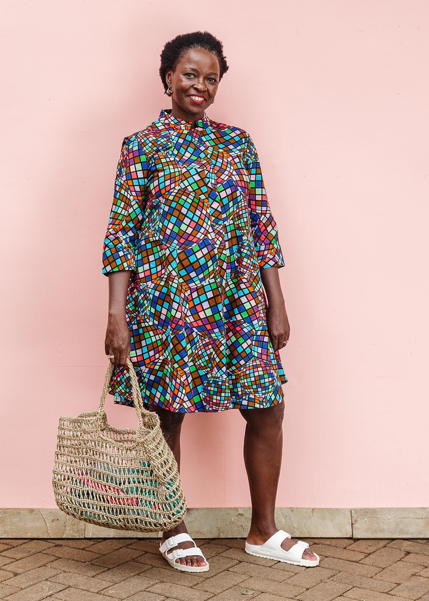 The model is wearing multi colored dress with disco ball print