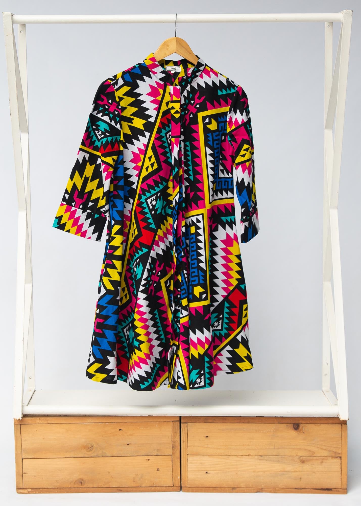 Display of multi colored geometric print dress