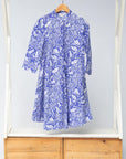 Display of violet and white leaf print dress