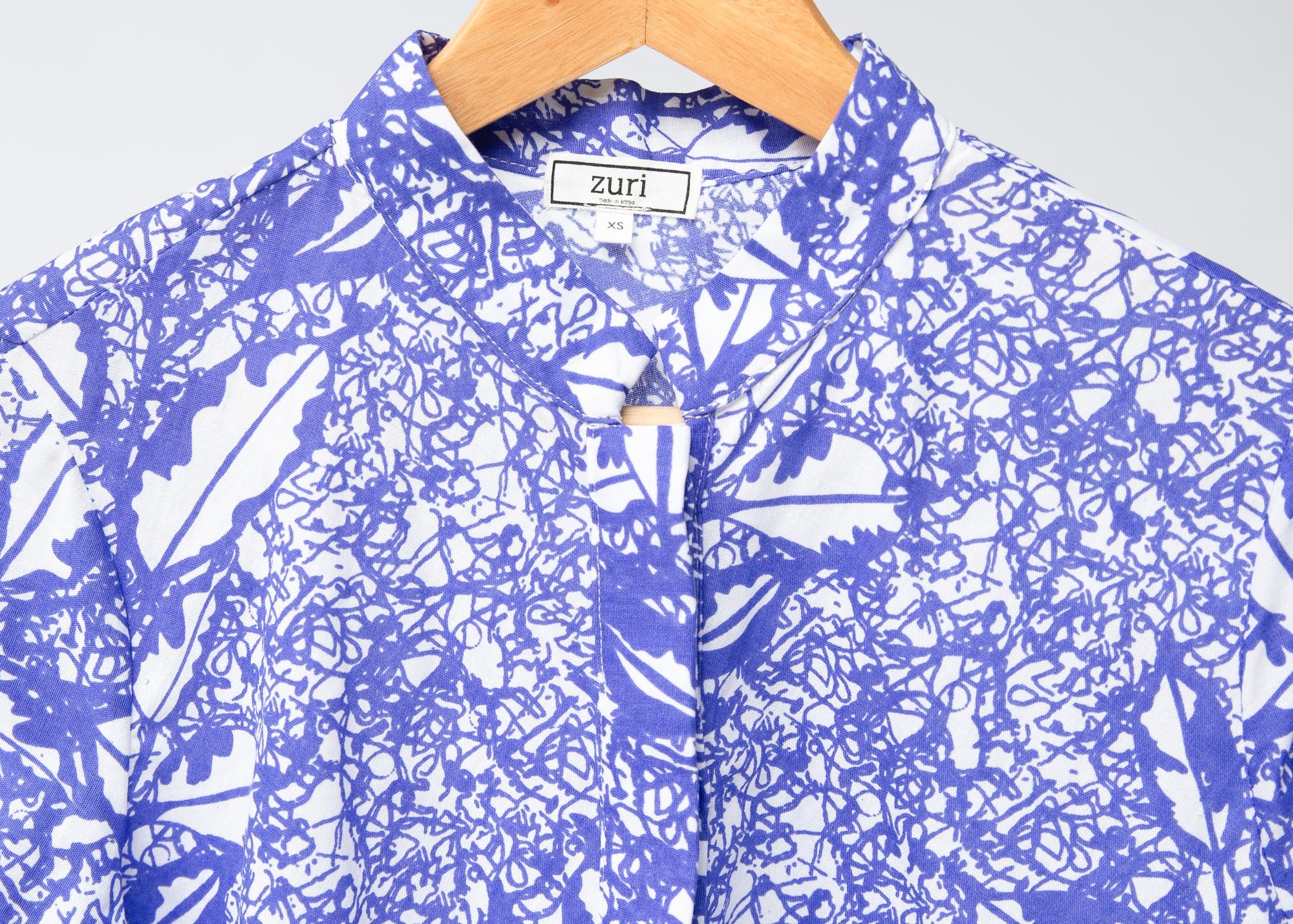 Display of violet and white leaf print dress