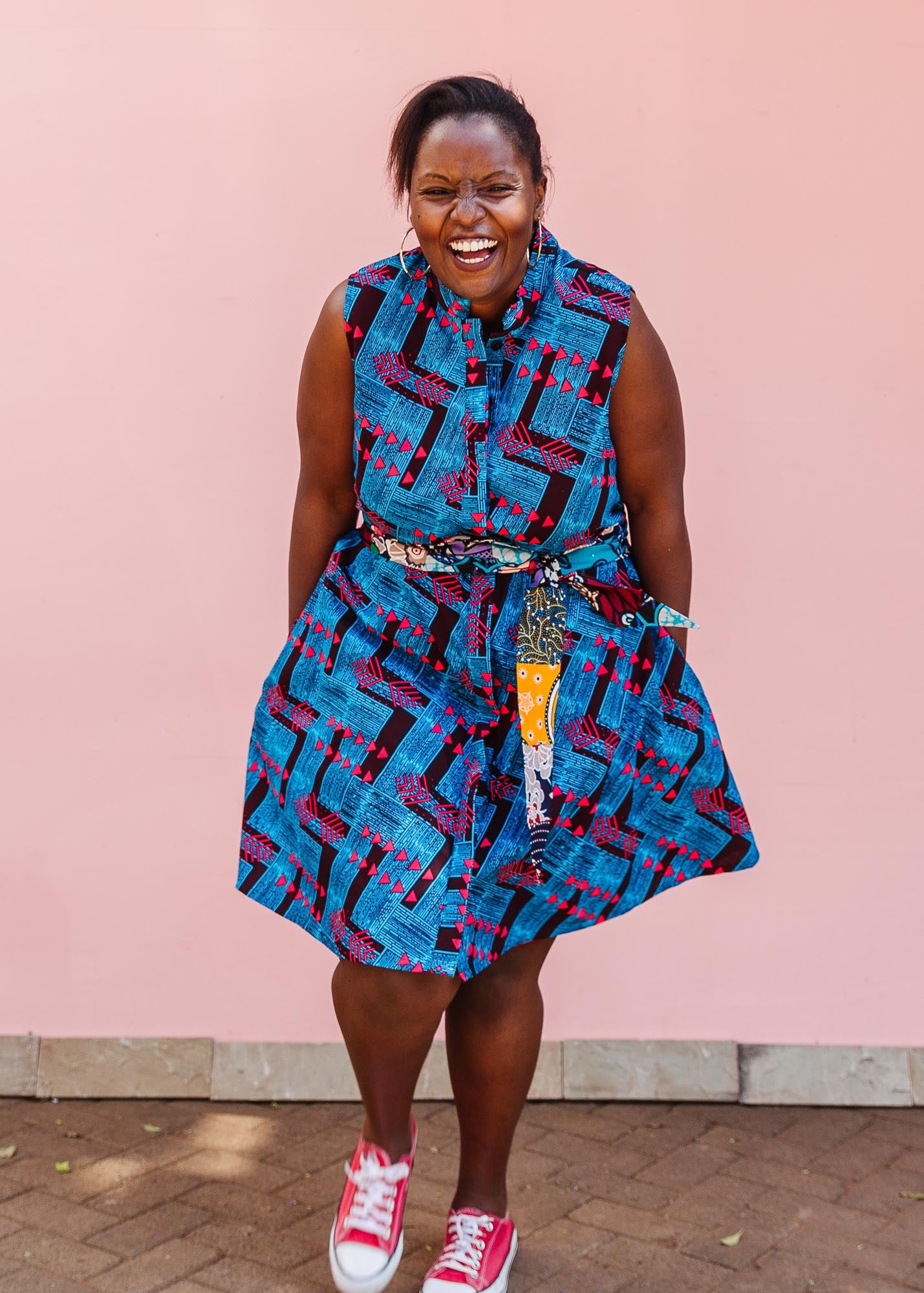 The model is wearing black, blue and hot pink geometric print dress