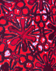 Close up display of red floral print sleeveless shirt, fabric.