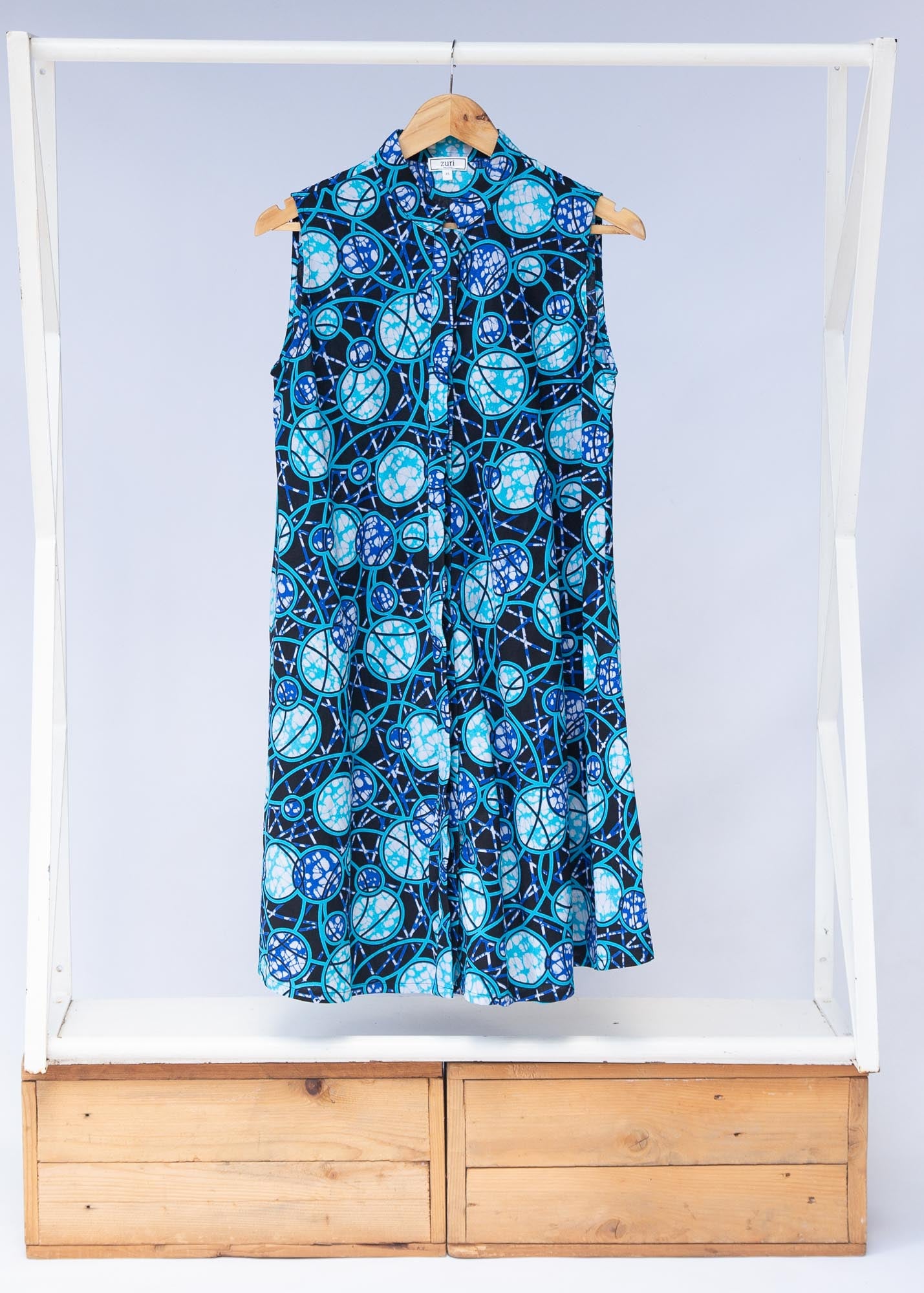 Display of black dress with blue white and aqua colored full moon