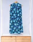 Display of black dress with blue white and aqua colored full moon
