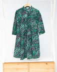 Display of black, green and white geometric print dress