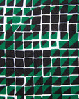 Close up display of black, green and white geometric print dress
