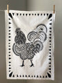 Display of tea towel with rooster print.