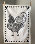 Display of tea towel with rooster print.