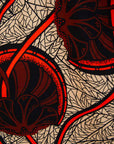 Close up display of beige shirt with brown and orange circles and lines, fabric.