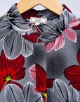 Display of dress with large grey and red flower print.
