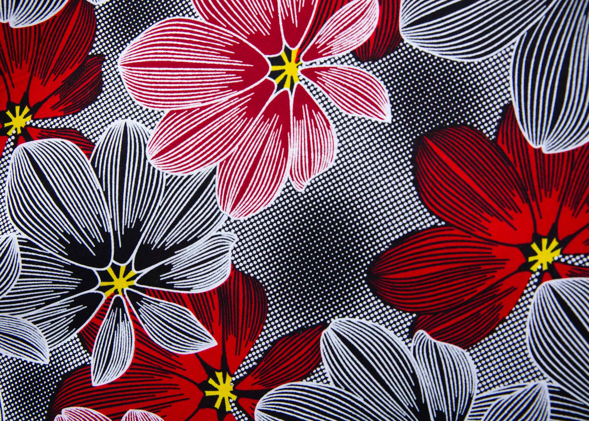 Close up display of dress with large grey and red flower print, fabric.