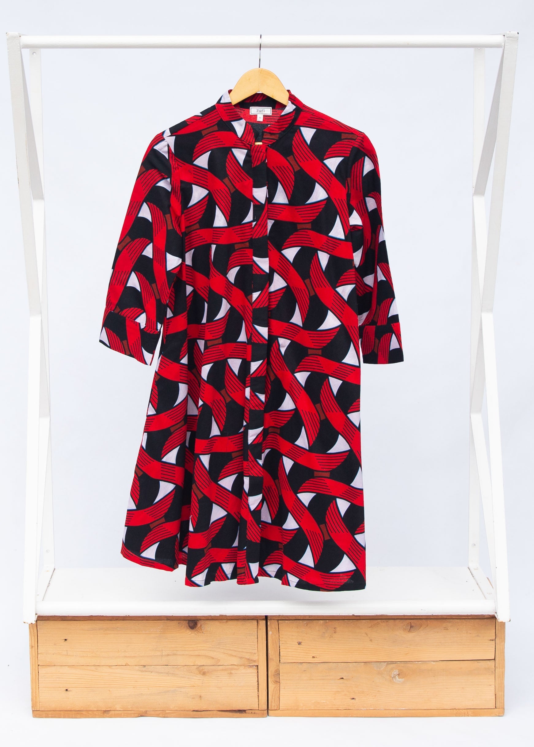 Display of red, black and white ribbon print dress.