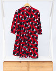 Display of red, black and white ribbon print dress.