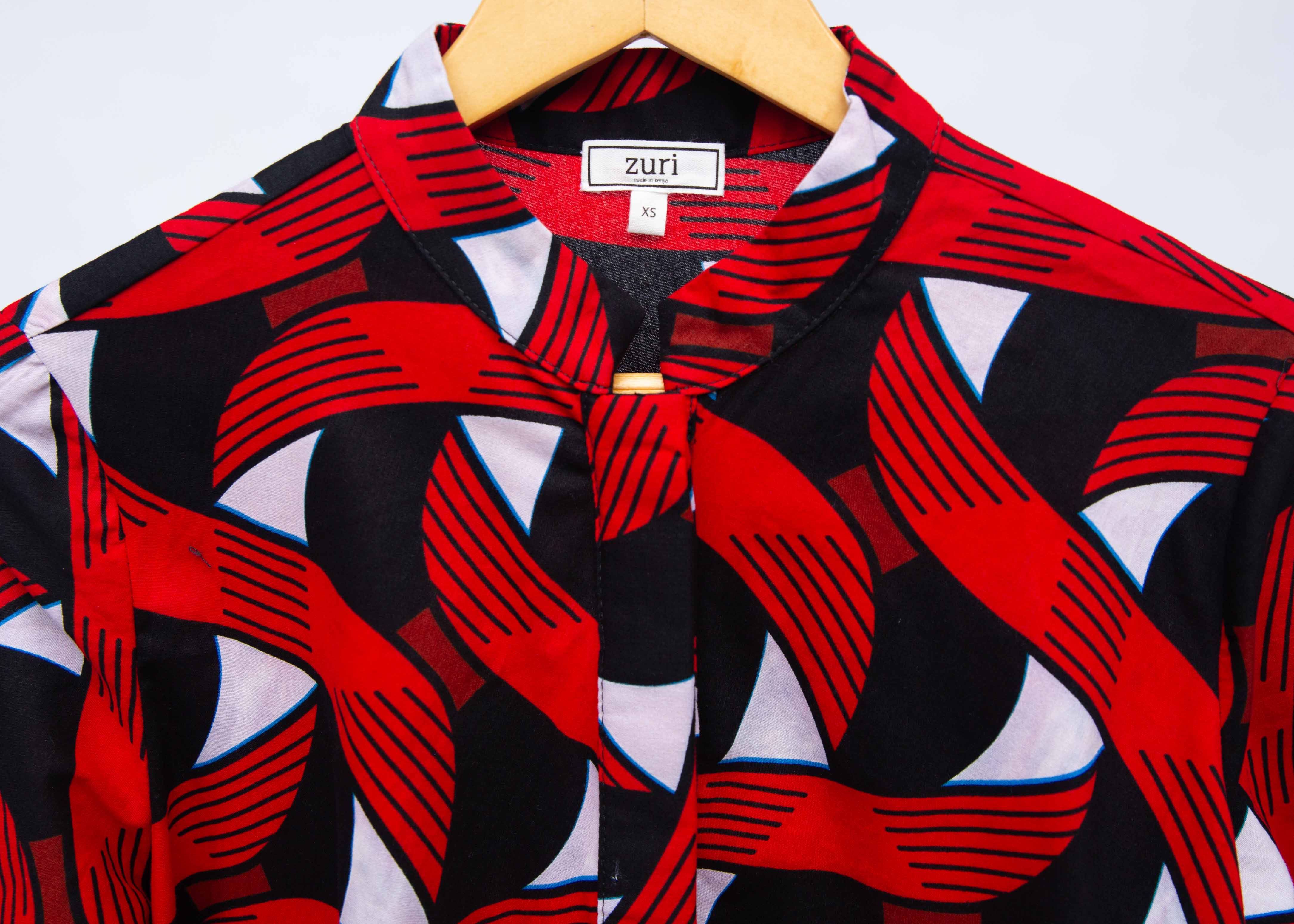 Display of red, black and white ribbon print dress.