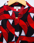 Display of red, black and white ribbon print dress.