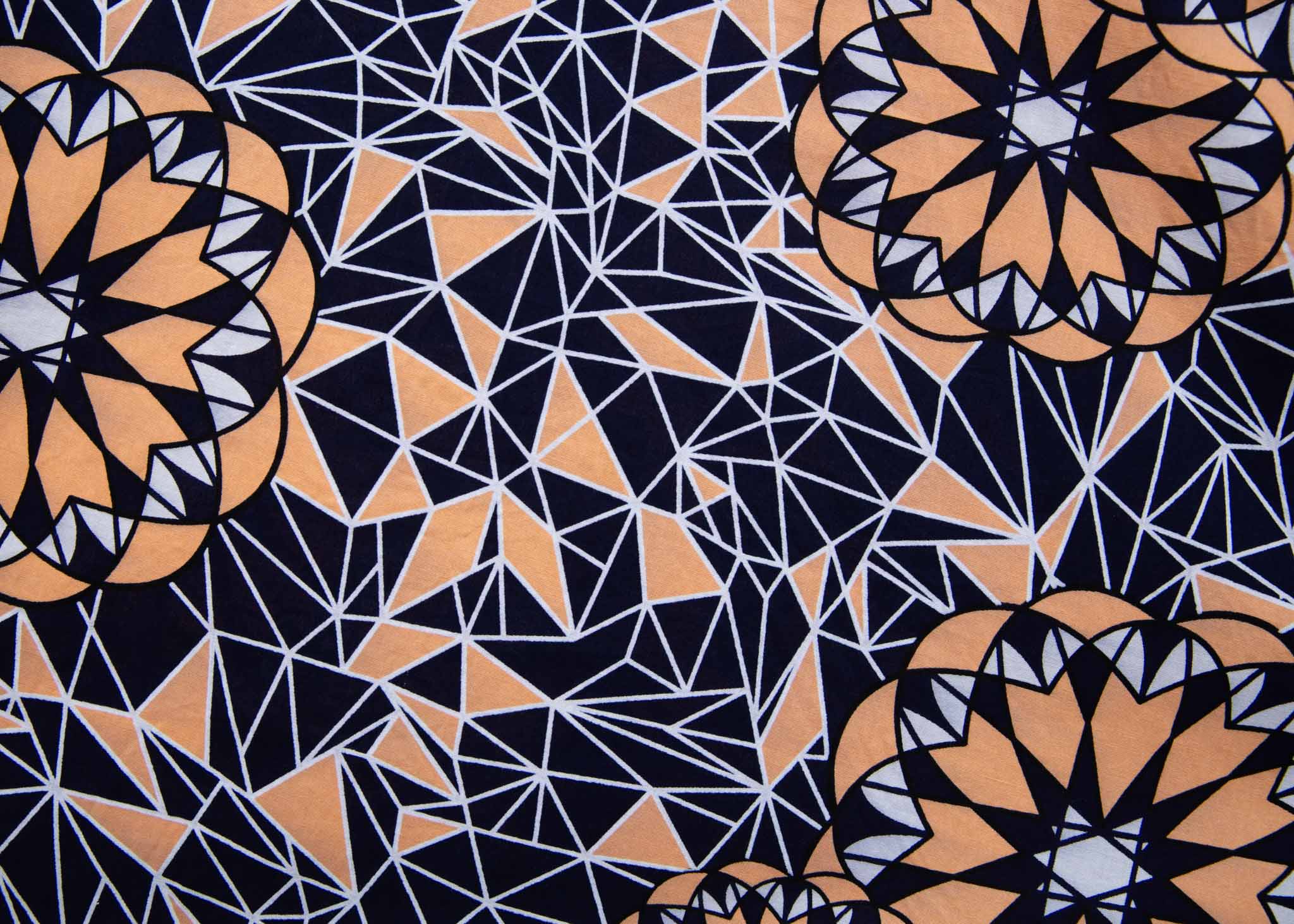 Close up Display of navy, beige and white geometric print dress, fabric.