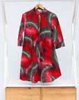 Display of red dress with black and white feather print.