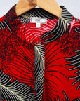 Display of red dress with black and white feather print.